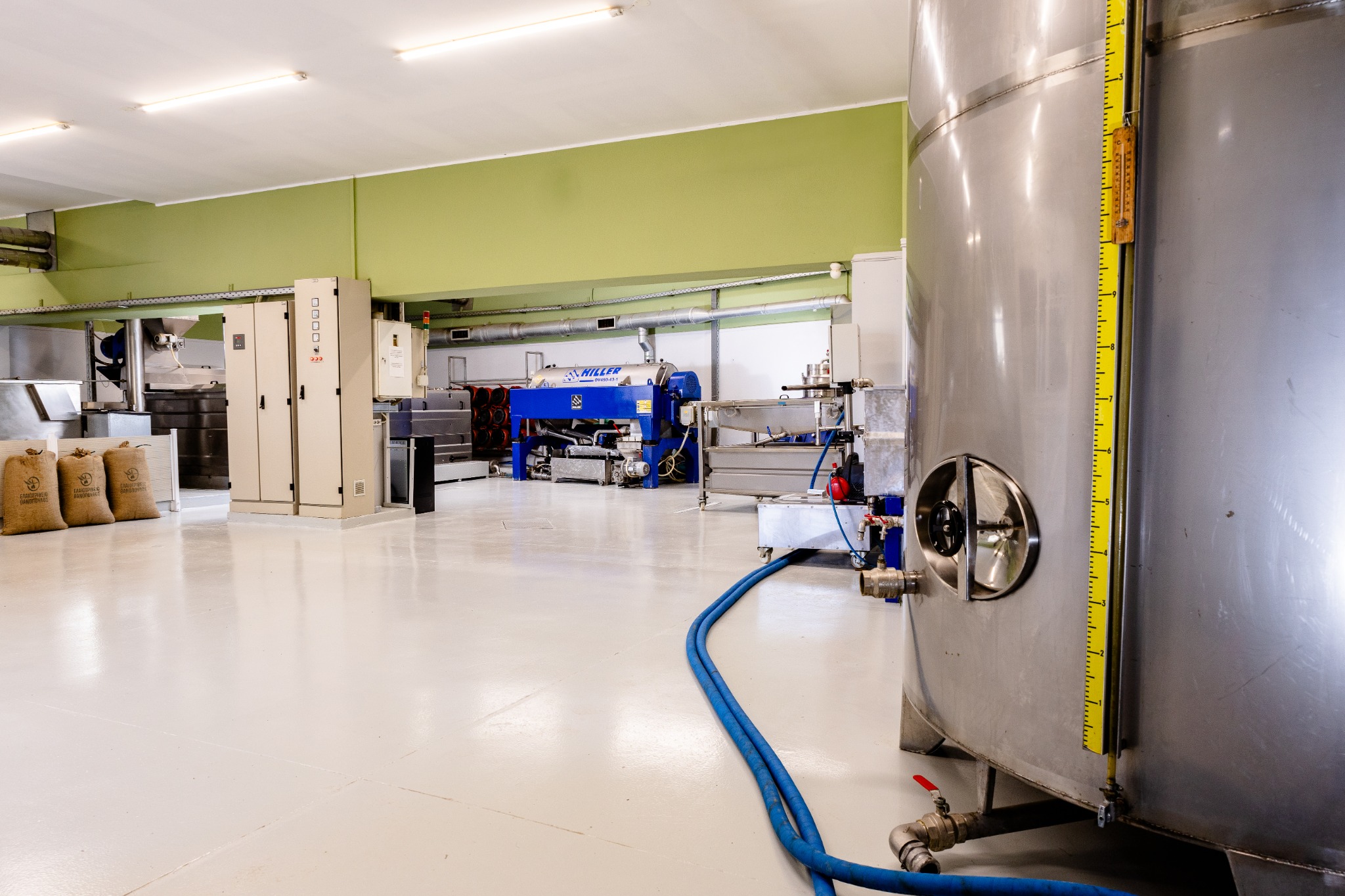 Production equipment and stainless-steel olive oil tanks at Thanopoulos Olive Mill